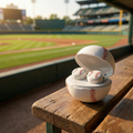 Baseball-themed wireless earbuds in a case on a wooden bench at a baseball stadium.