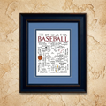 Baseball Calligraphy framed artwork with baseball-themed word cloud on a blue background, mounted on a textured beige wall.