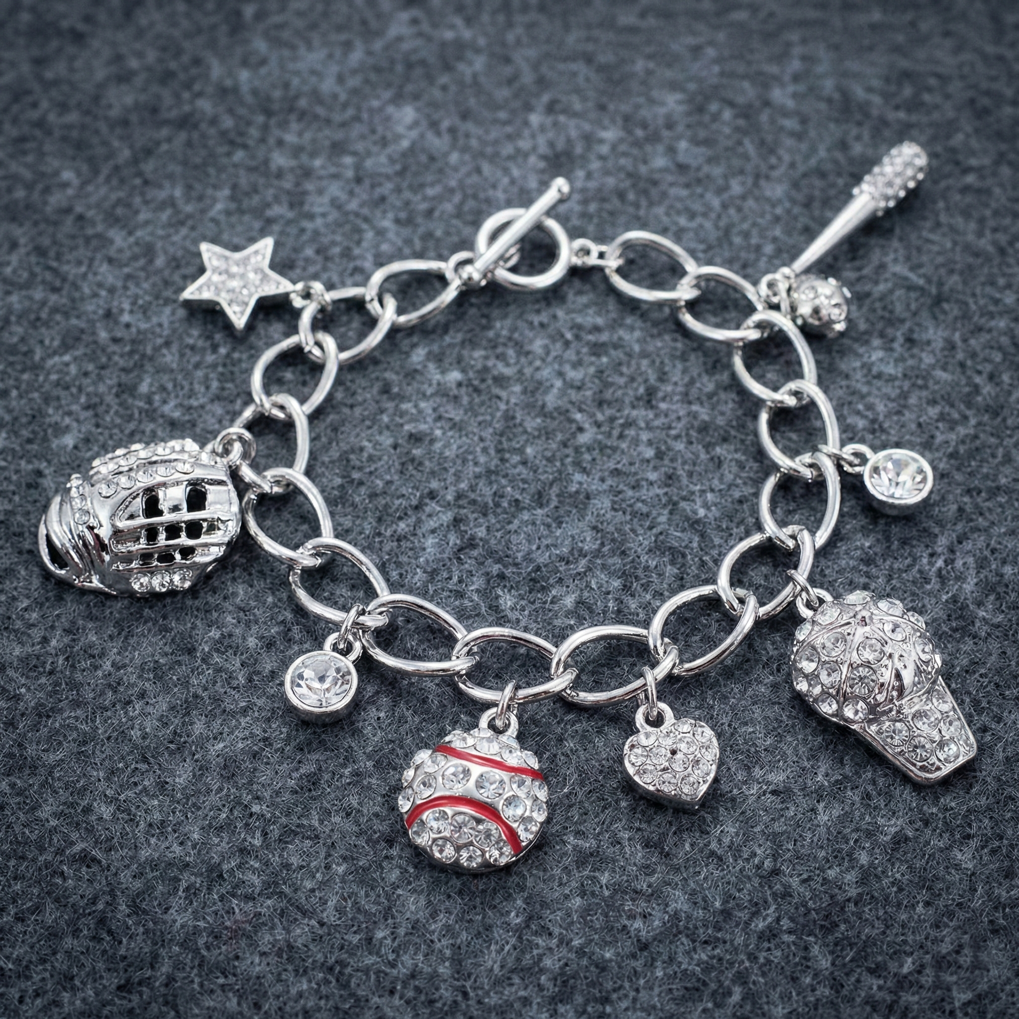 Baseball Charm Toggle Link Bracelet on a dark, fuzzy background
