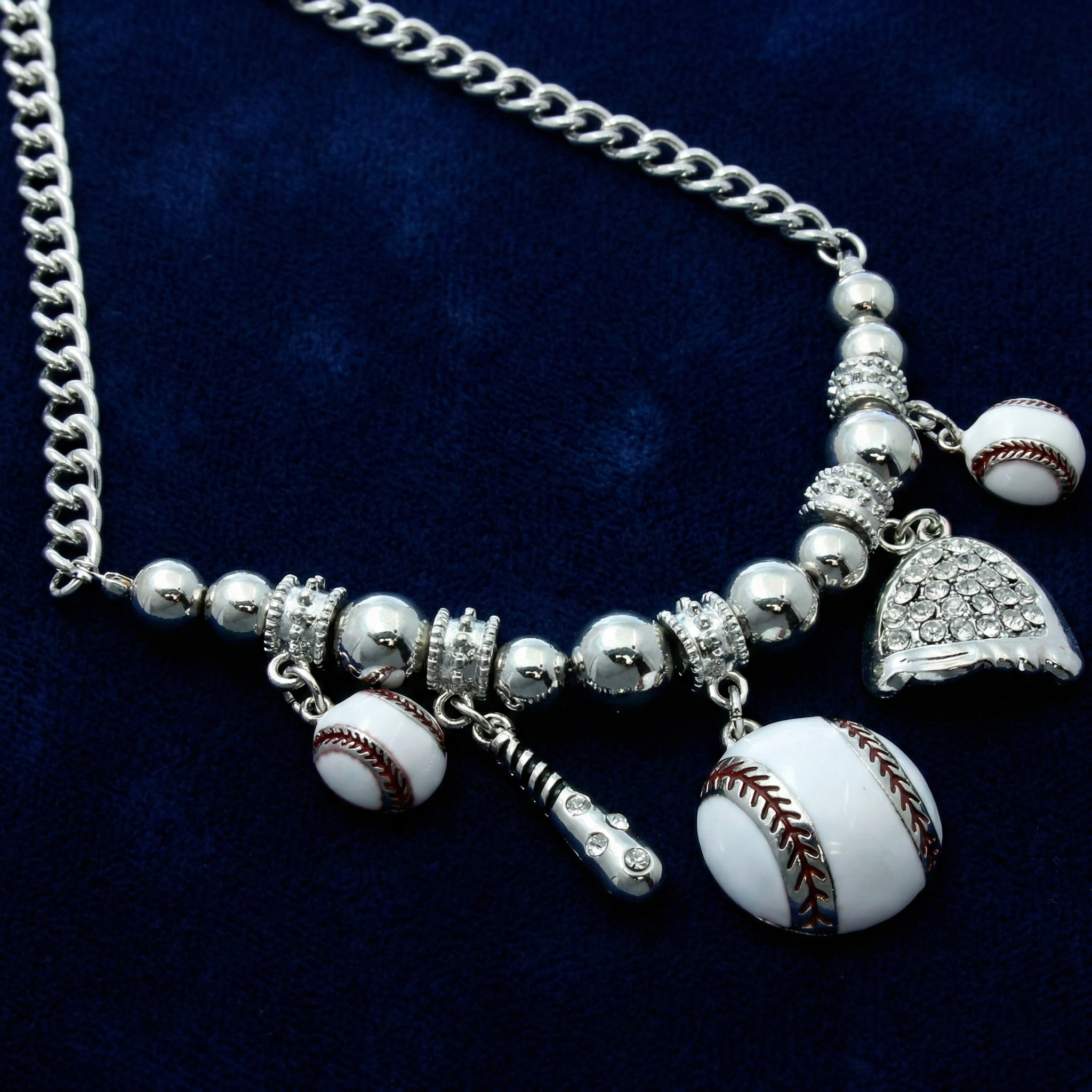 Necklace with baseball-themed charms on a dark blue background