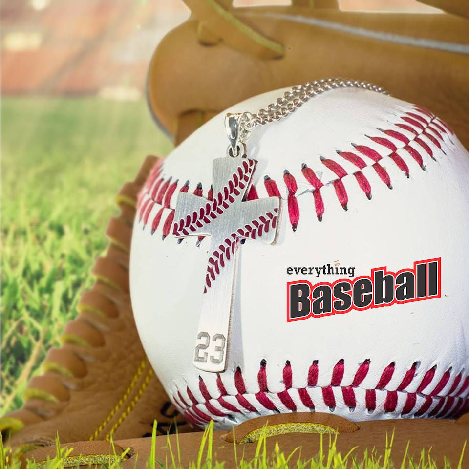 Baseball with 'everything Baseball' branding and a baseball number cross pendant on a wooden base.