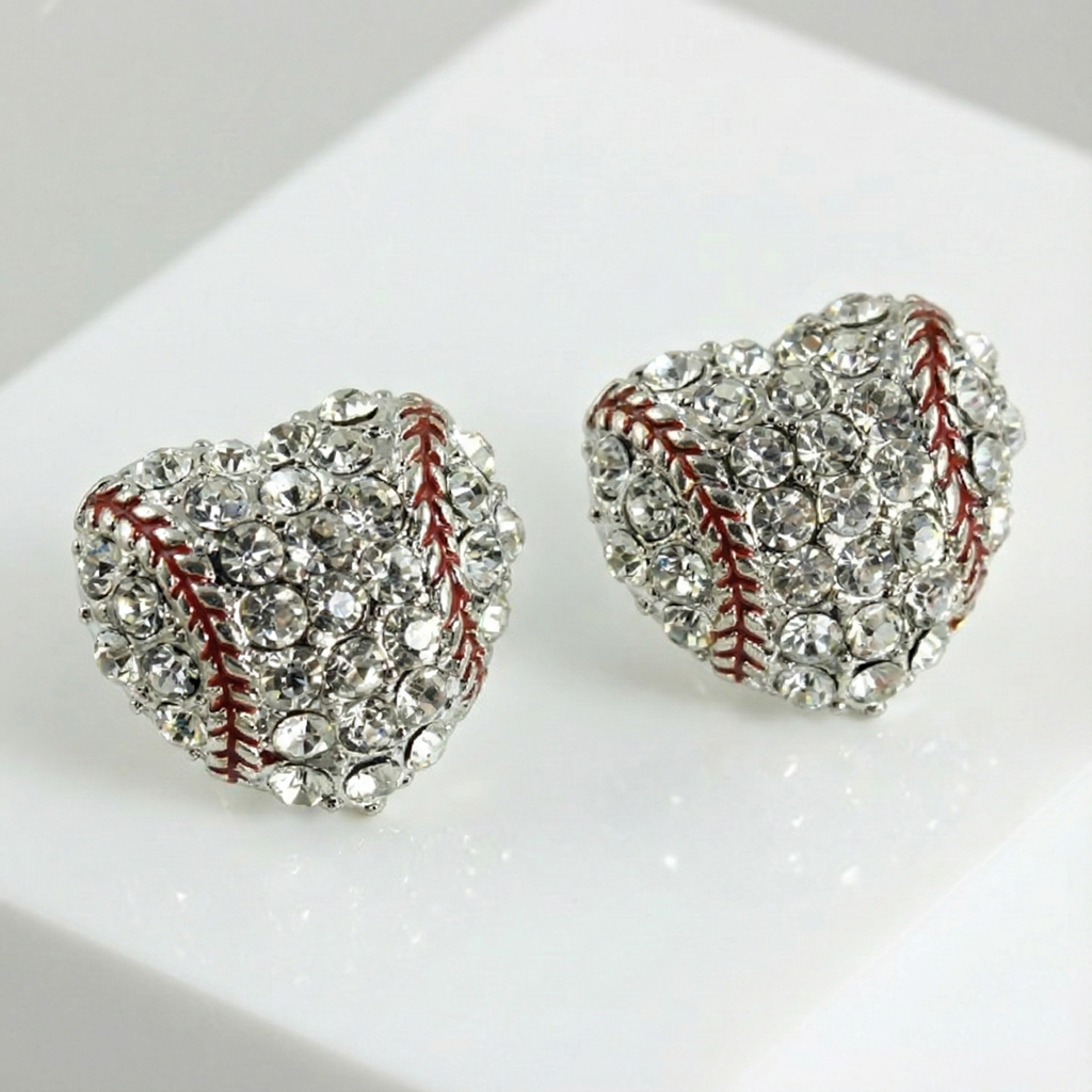 Heart-shaped crystal earrings with baseball design on a white surface