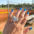 Hand wearing Baseball Crystal Heart Stretchy Ring on a sports field background