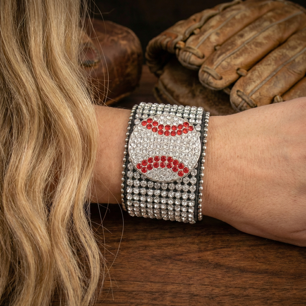 Baseball Crystal Cuff Bracelet on a woman's wrist near baseball equipment