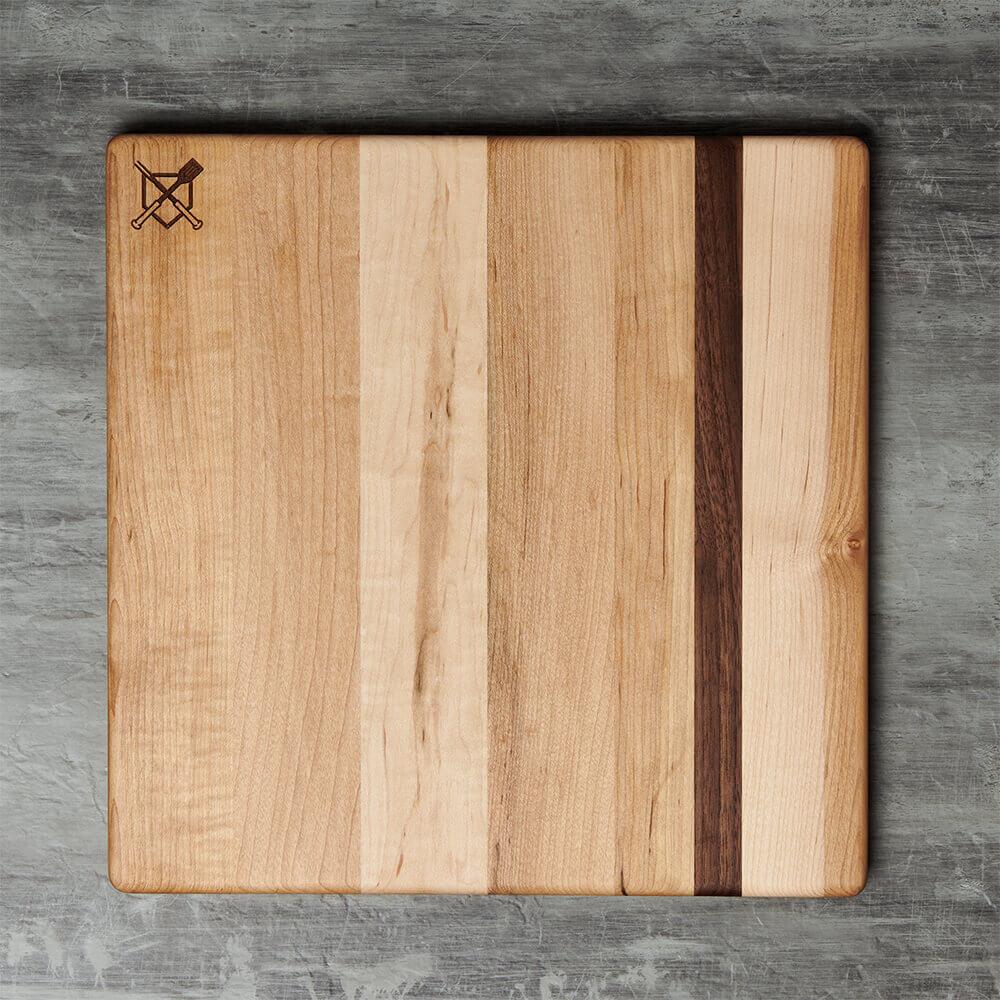 Wooden baseball bbq cutting board with a natural grain pattern on a gray surface