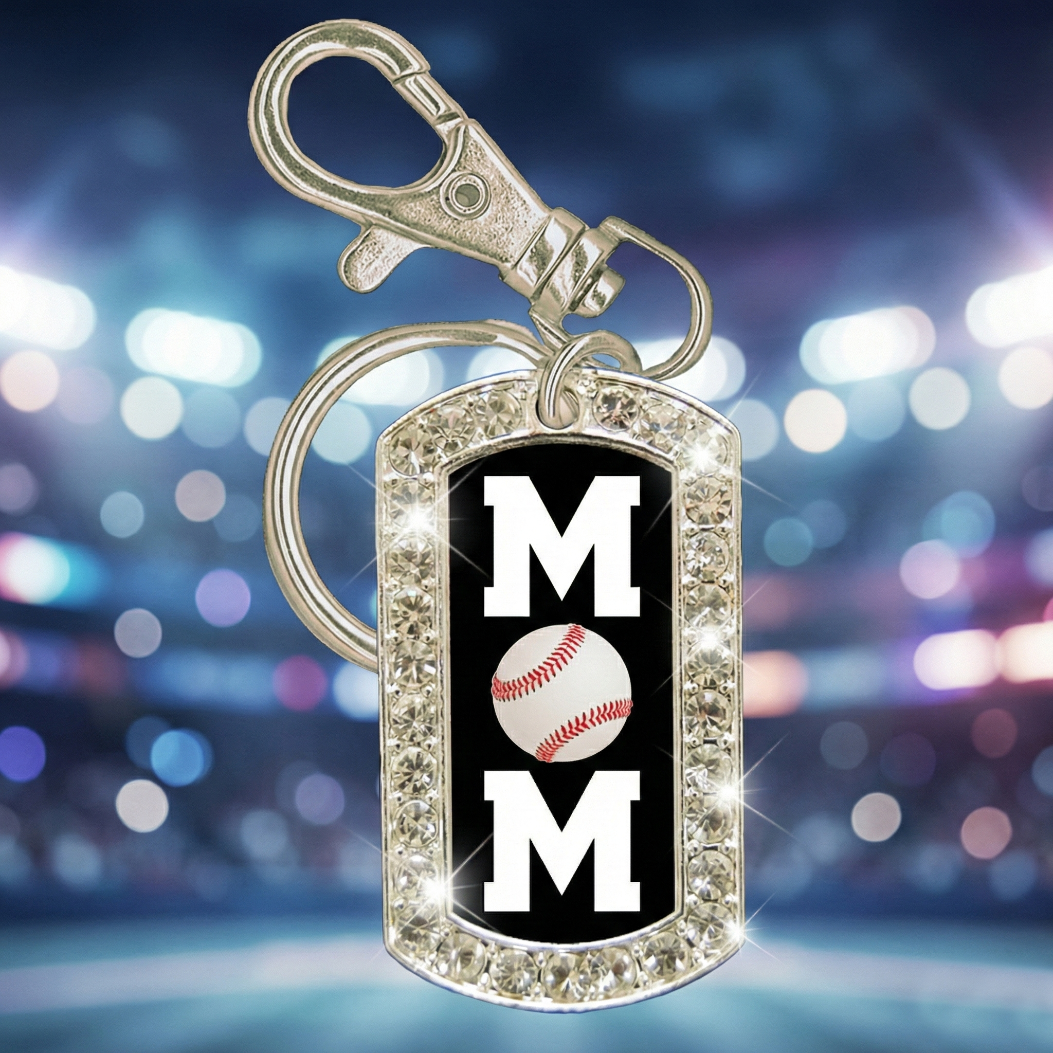 Keychain with 'MOM' and baseball design on a blurred lights background