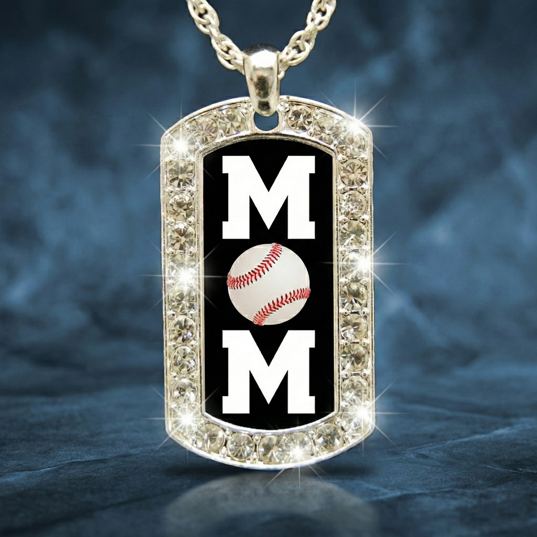 Dog tag pendant with 'MOM' and baseball design on a dark background