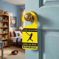 Door hanger with baseball theme in a room with books and a bed.
