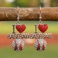 I love baseball earrings with 'I ❤️ BASEBALL' design hanging on a wood bat with a blurred natural background.