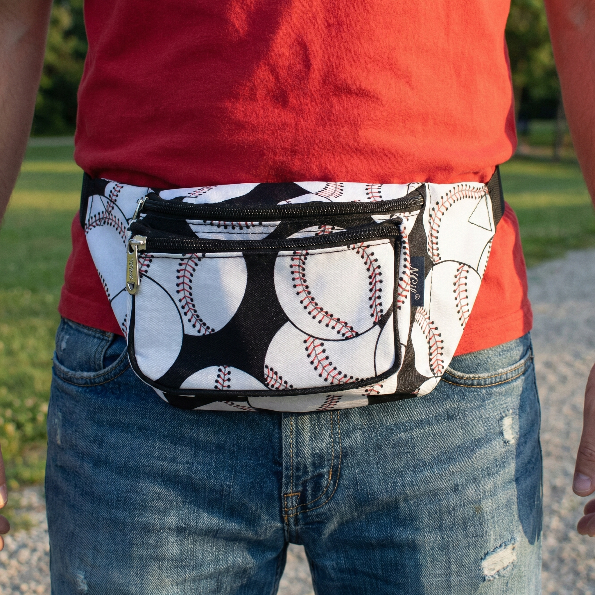 Person wearing a fanny pack with baseball pattern outdoors