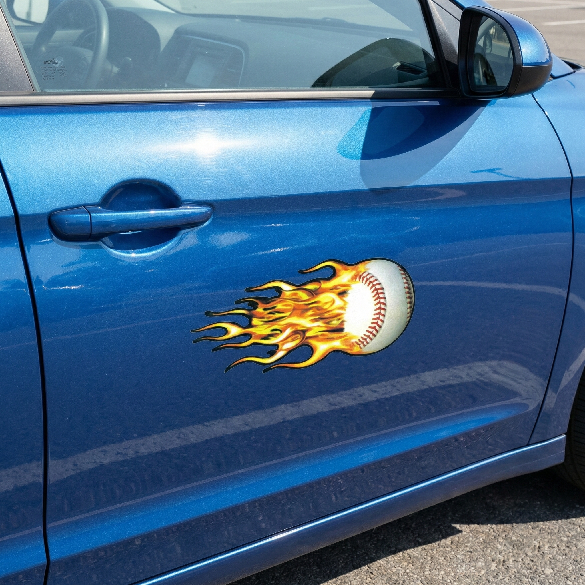 Blue car with a fiery baseball decal on the side