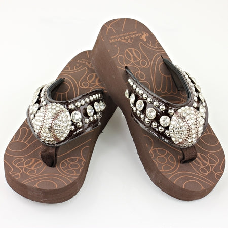 Brown sandals with decorative straps featuring pearls and crystals on a white background