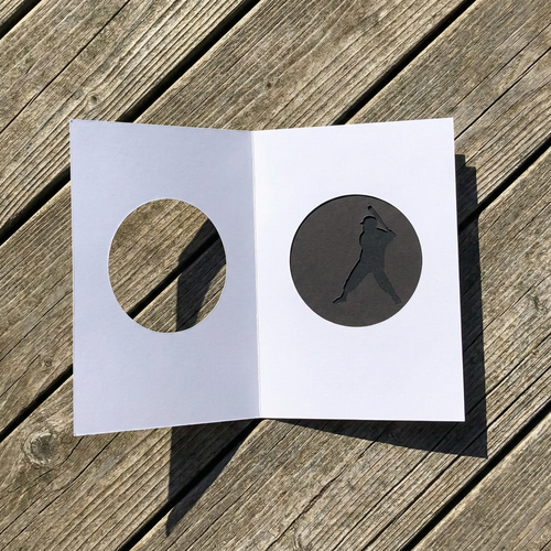 Open greeting card with moving batter and opening on the front on a wooden surface