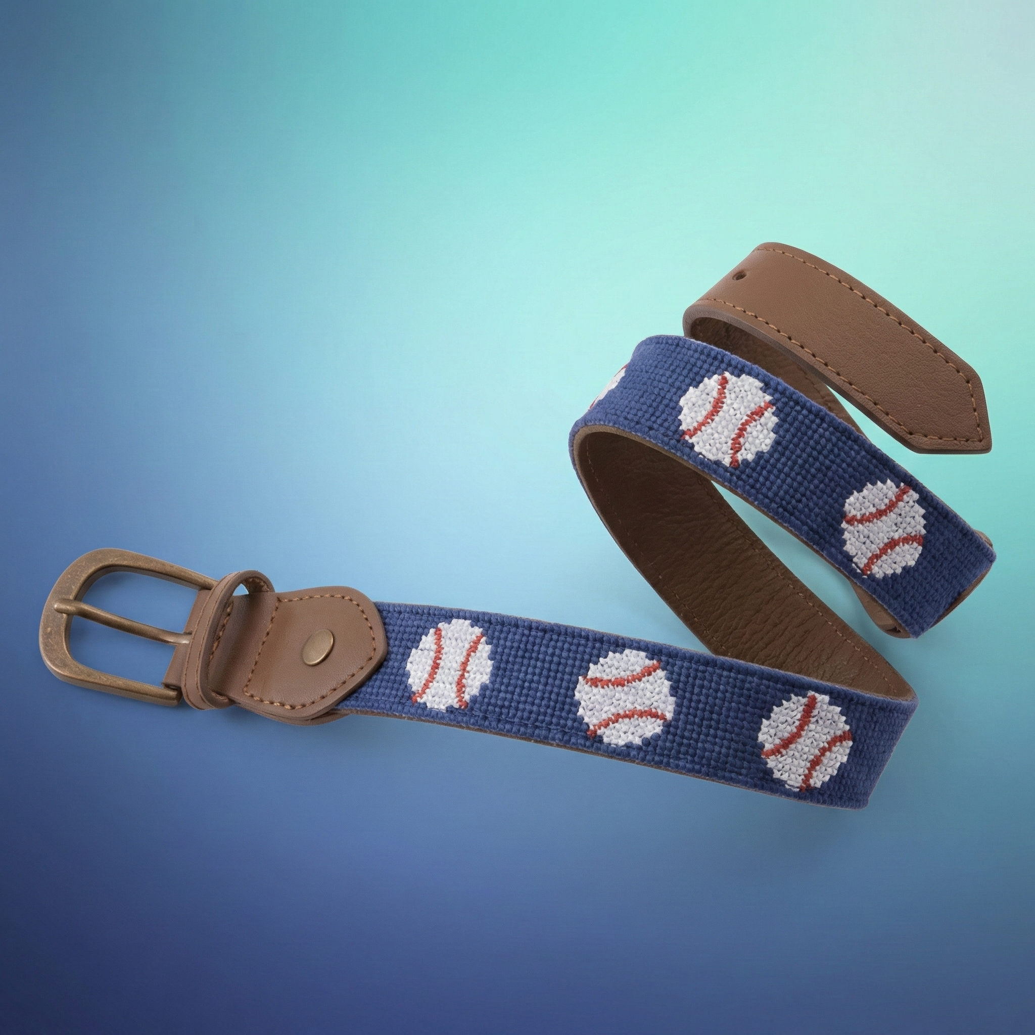 Needlepoint Leather Baseball Belt on blue gradient background