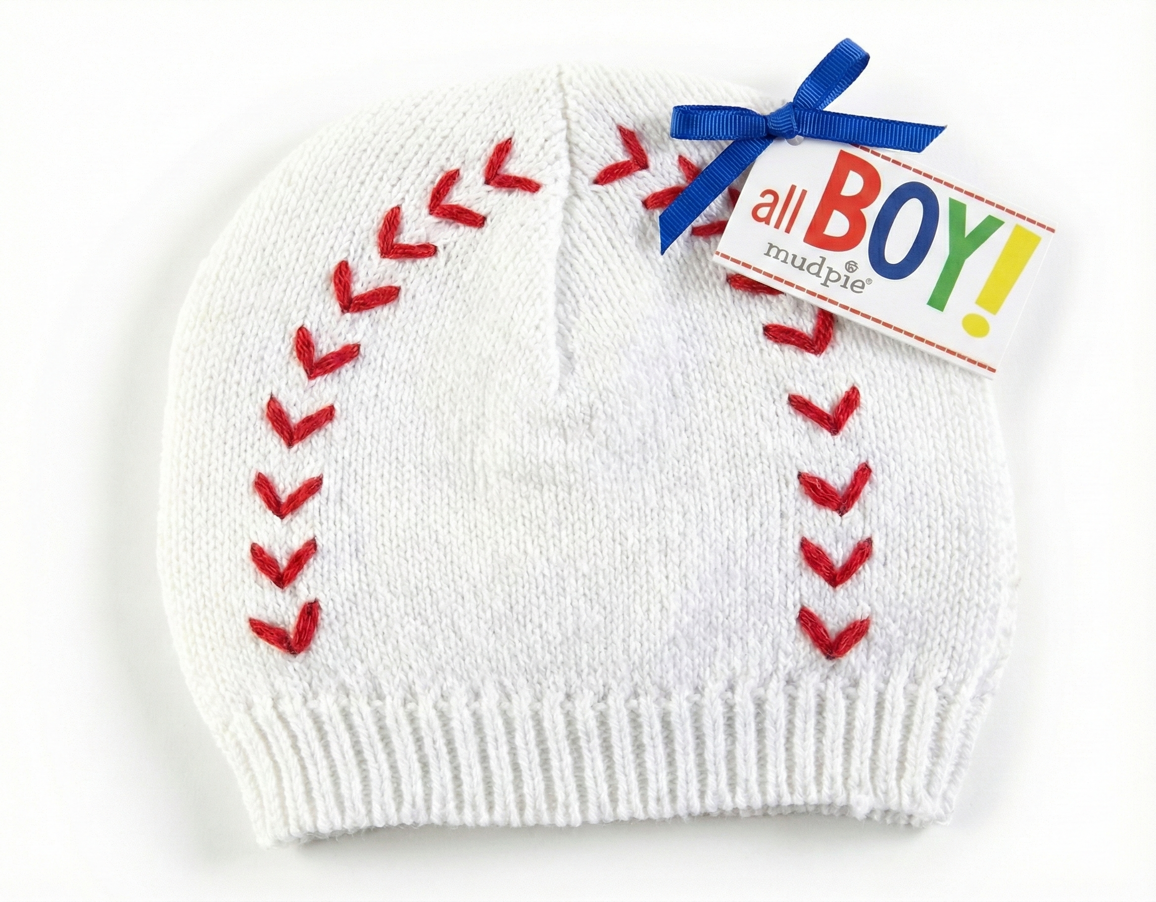 White baby knit winter hat with red baseball stitching and a colorful 'all BOY!' tag on a white background