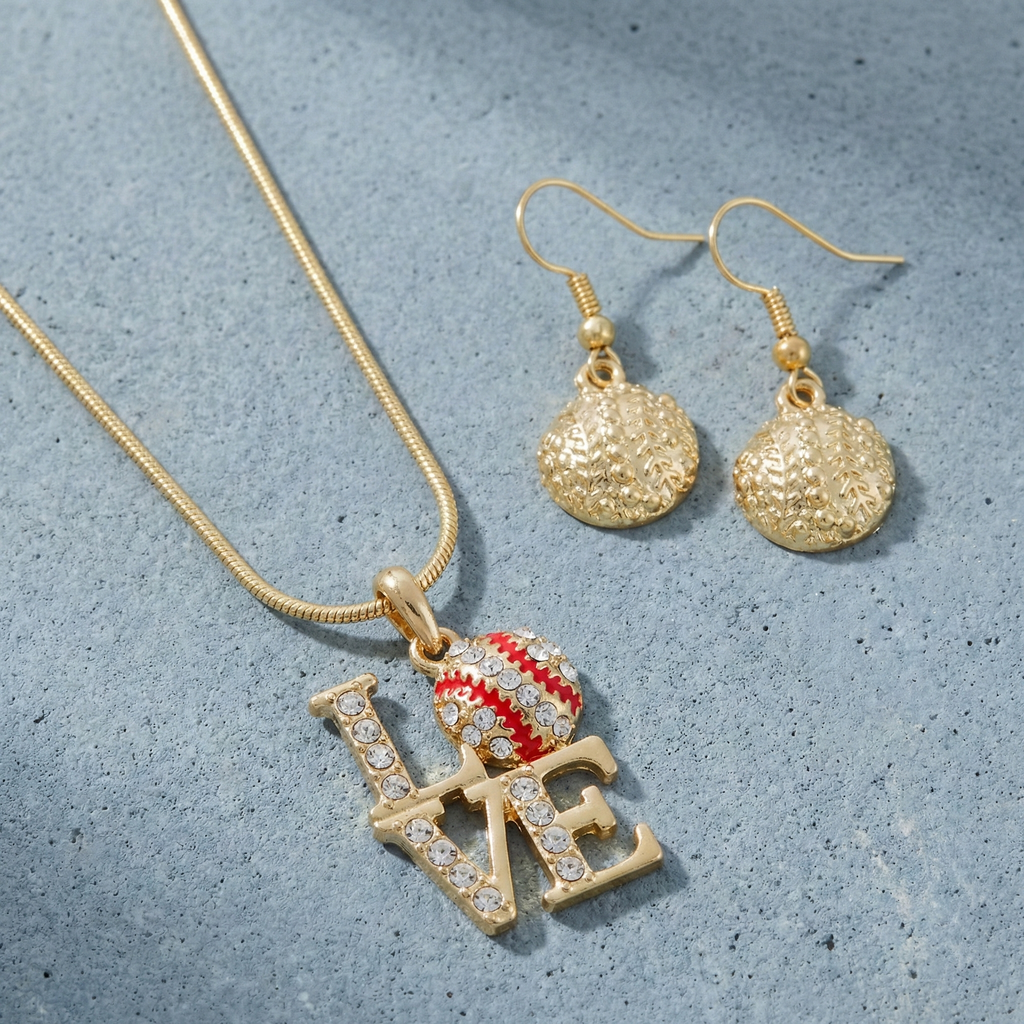 Gold necklace with baseball 'LOVE' pendant and matching earrings on a textured gray surface