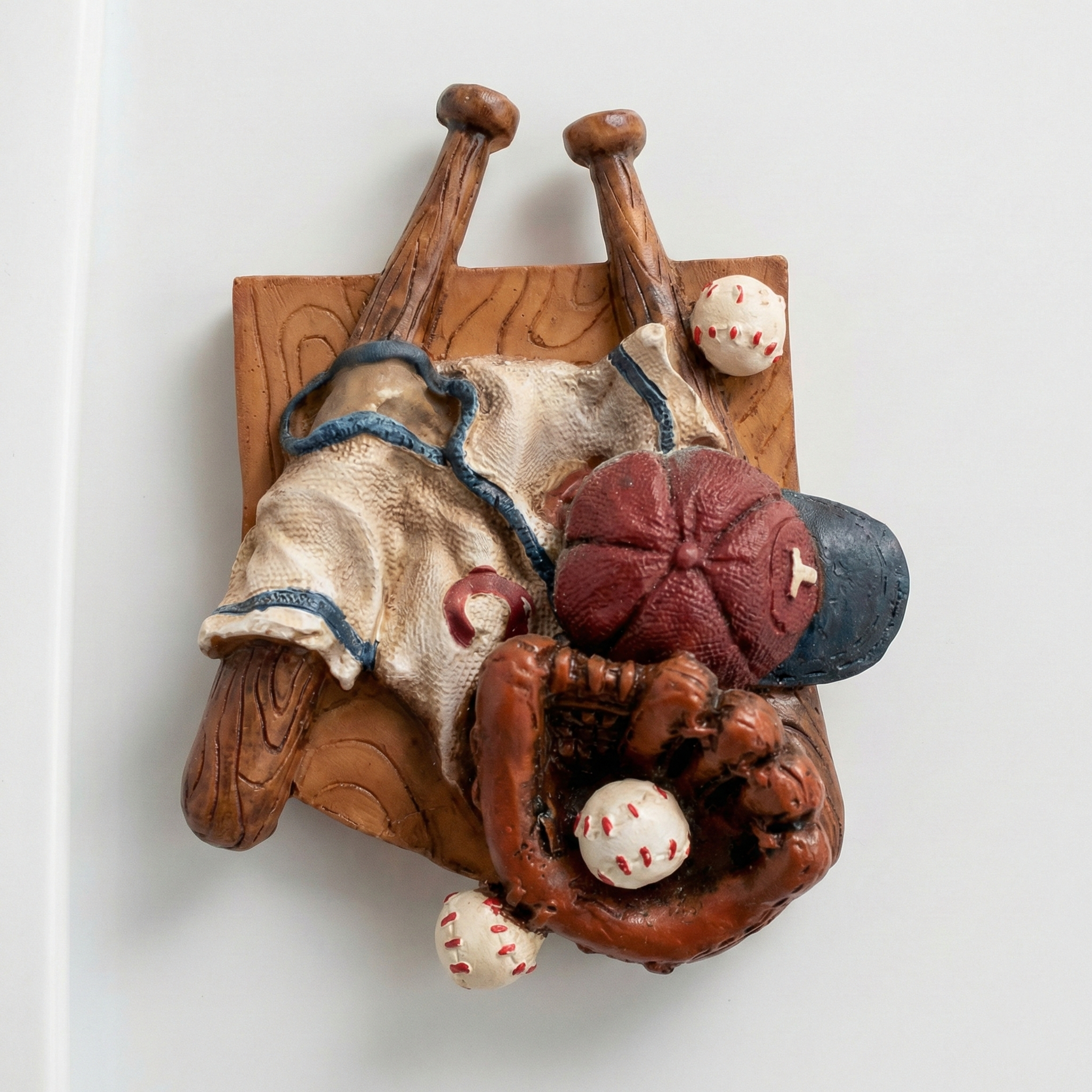 Baseball-themed decorative magnet with a bat, glove, balls, and cap on a white background