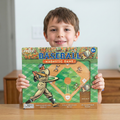 Child holding a baseball magnetic game box with a plain background