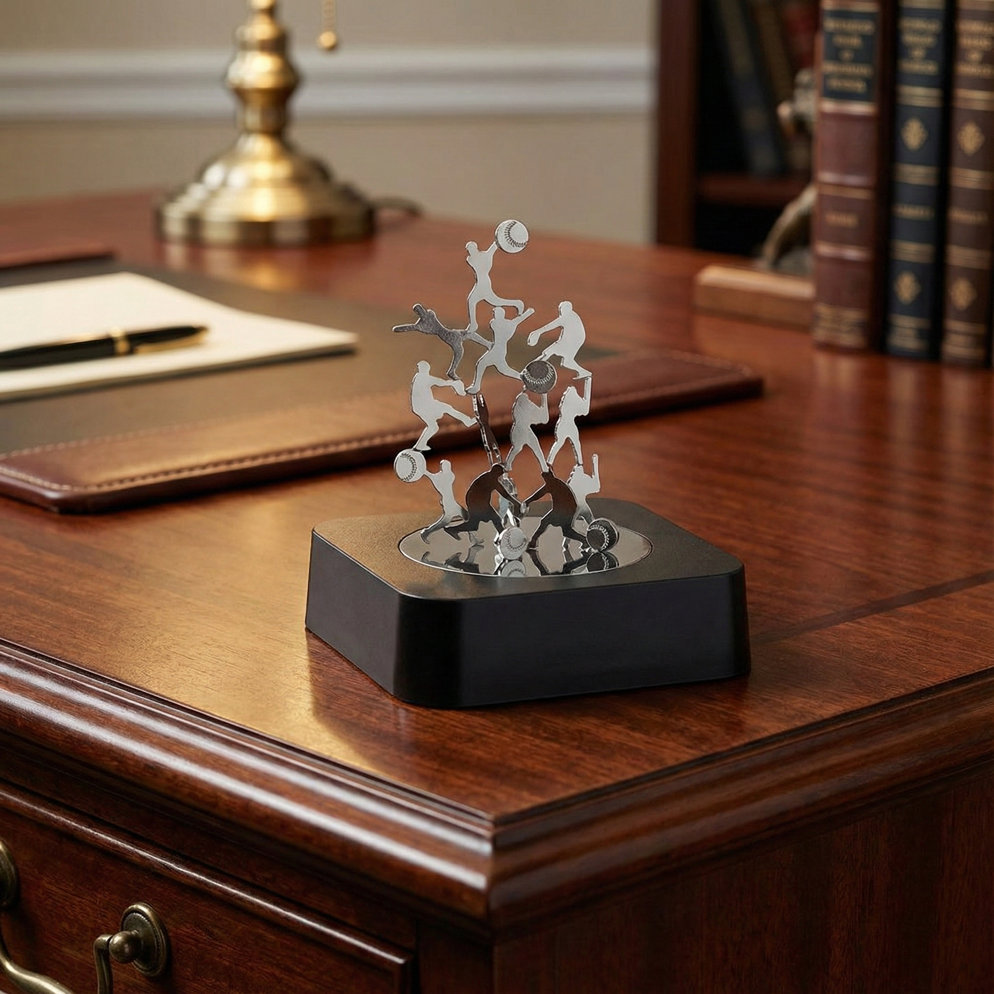 Baseball Magnetic Sculpture Block on a wooden desk with books and a lamp in the background