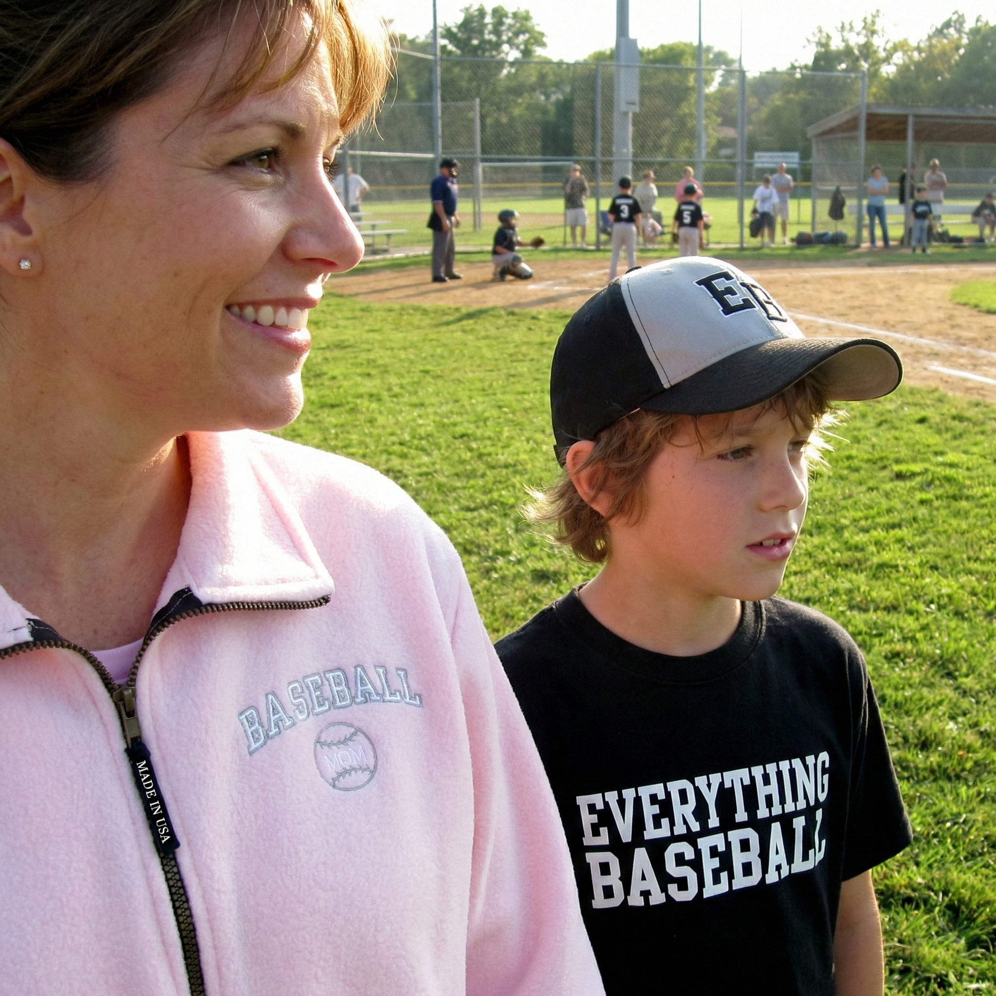 Baseball mom and young boy on a baseball field with 'Everything Baseball' t-shirt