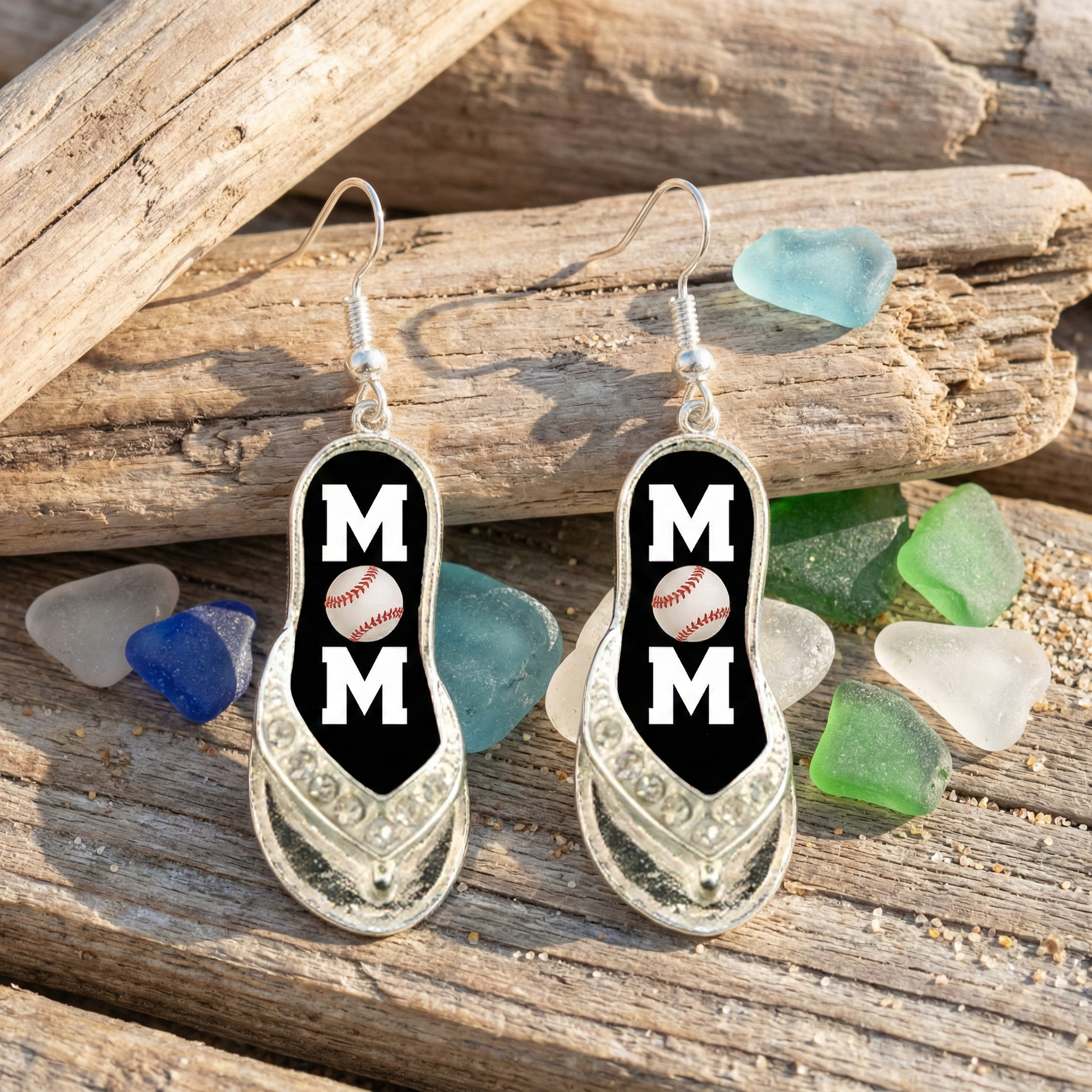 baseball mom flip flop earrings displayed near sea glass.