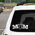 White car with Baseball Mom decal featuring a heart and baseball on a black window, baseball field background.