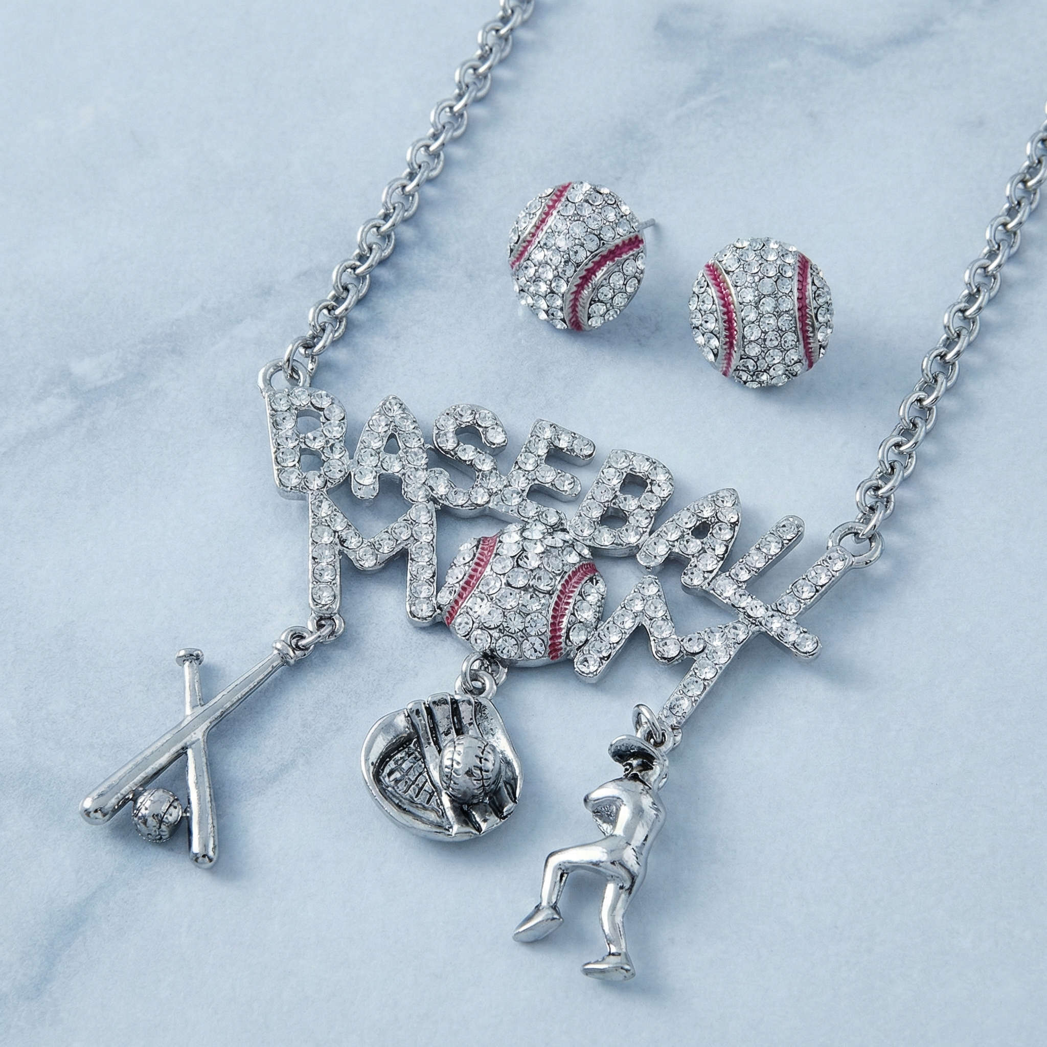 Jewelry set with 'Baseball Mom' necklace, earrings, and charms on a light blue background
