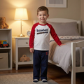 Child wearing a baseball #17 pajamas in a bedroom setting