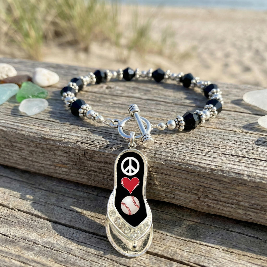 peace love baseball flip flop toggle bracelet near the beach displayed on wood with colorful sea glass. 