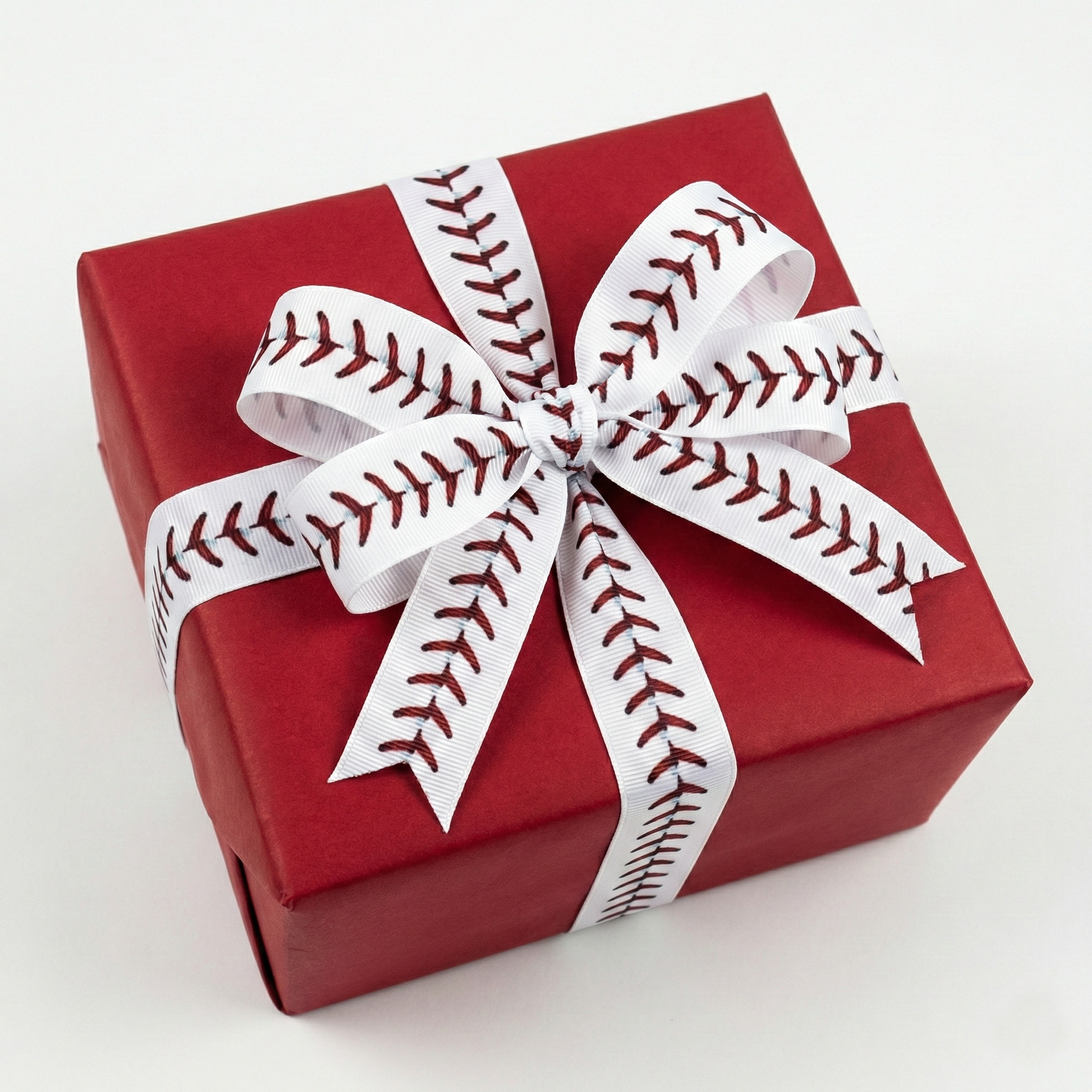 Red gift box with a white baseball-themed ribbon on a white background