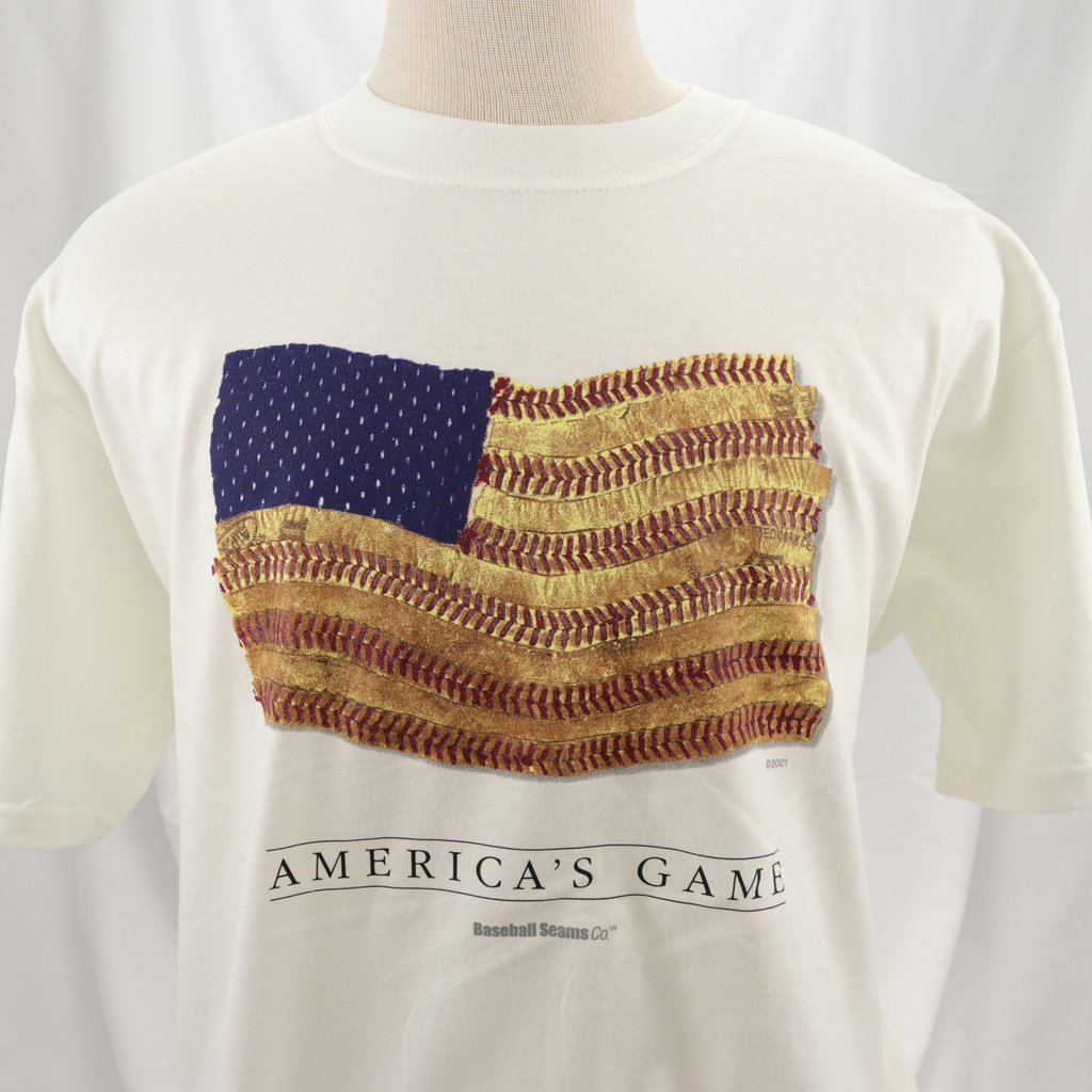 White t-shirt with American flag design and 'America's Game' text on a mannequin against a white background