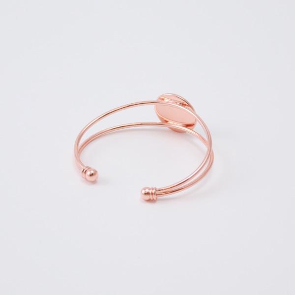 Rose gold bracelet on a light gray background