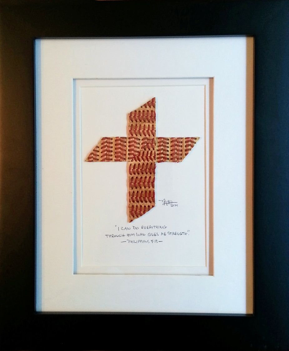 Framed artwork with a baseball seams cross design and text on a dark background