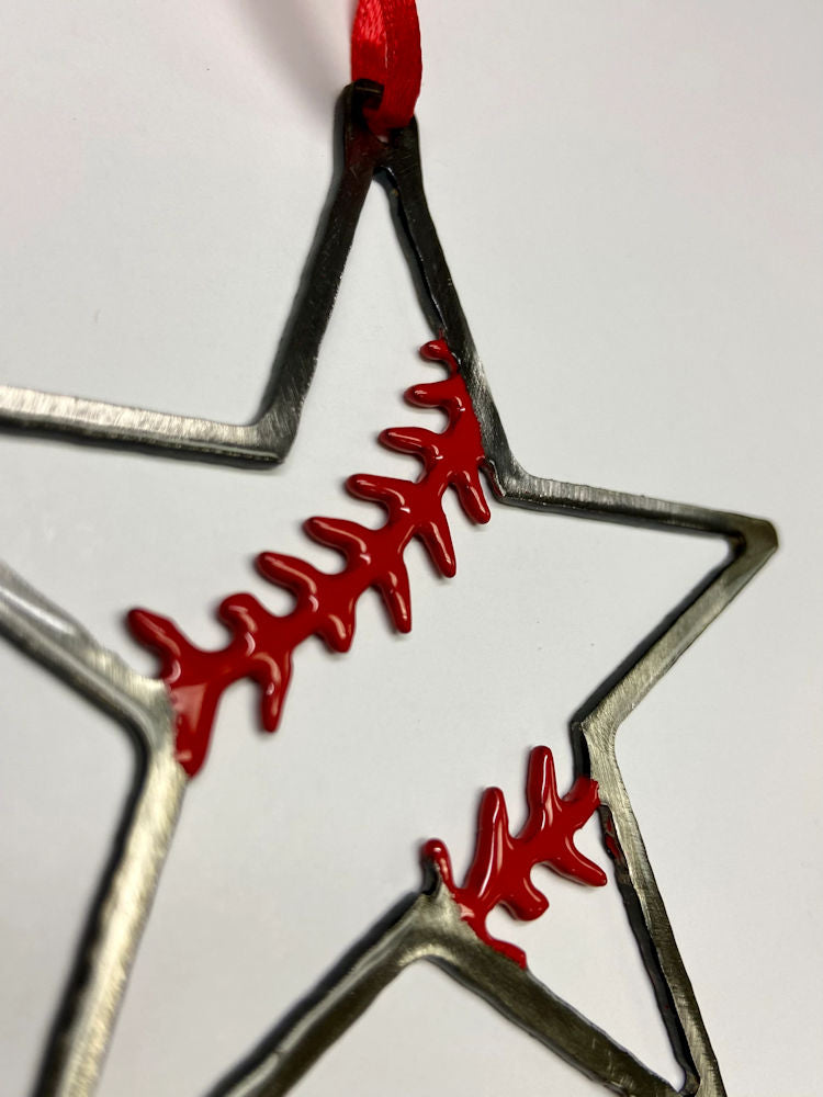 Star-shaped metal baseball ornament with red accents on a white background