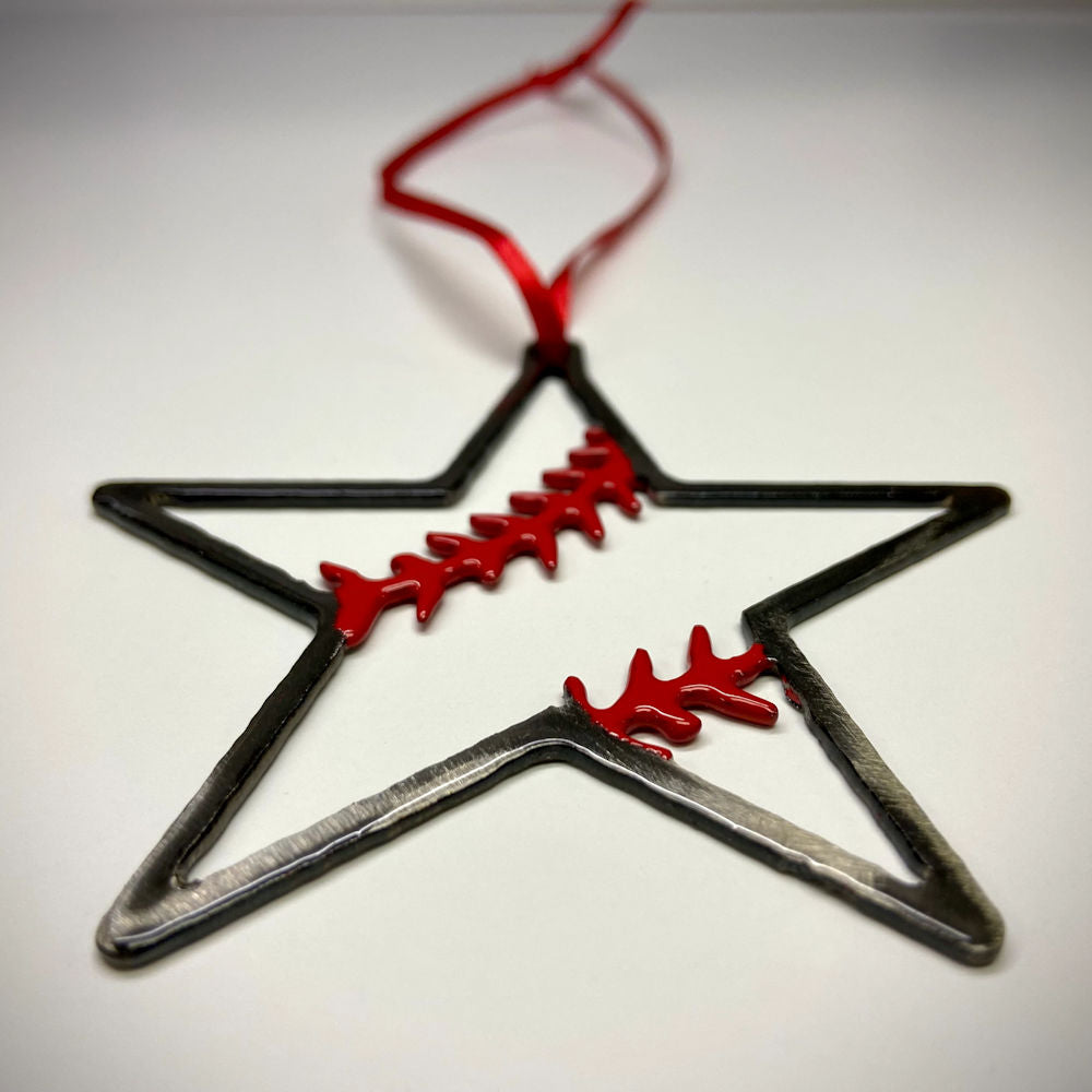 Star-shaped metal baseball ornament with red details on a white background