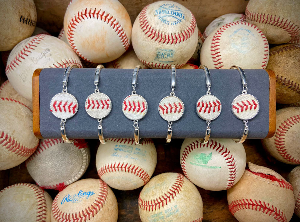 baseball seams silver bracelets with used baseballs background