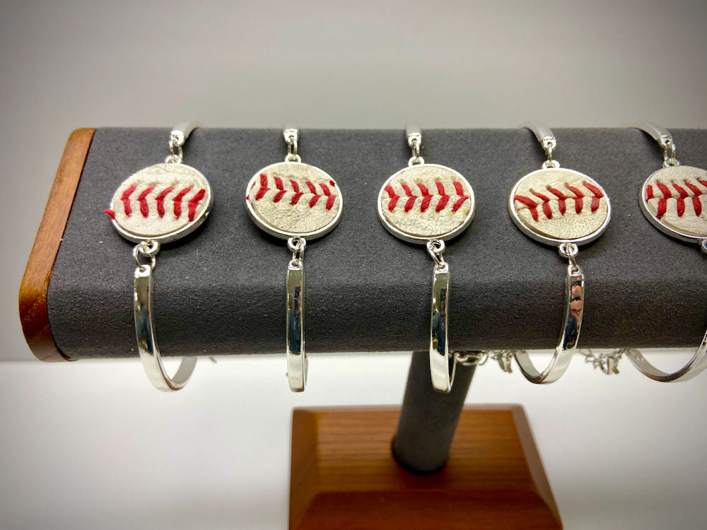 baseball seams silver bracelets on a jewelry stand