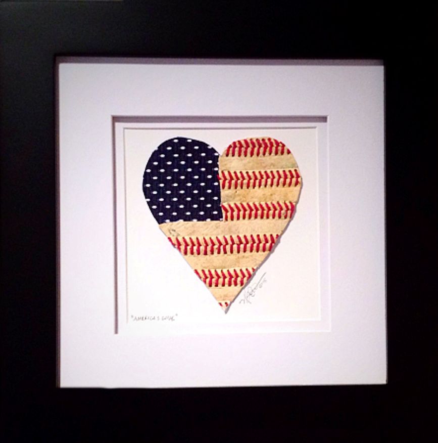 Framed artwork of a heart-shaped design combining American flag and baseball patterns.