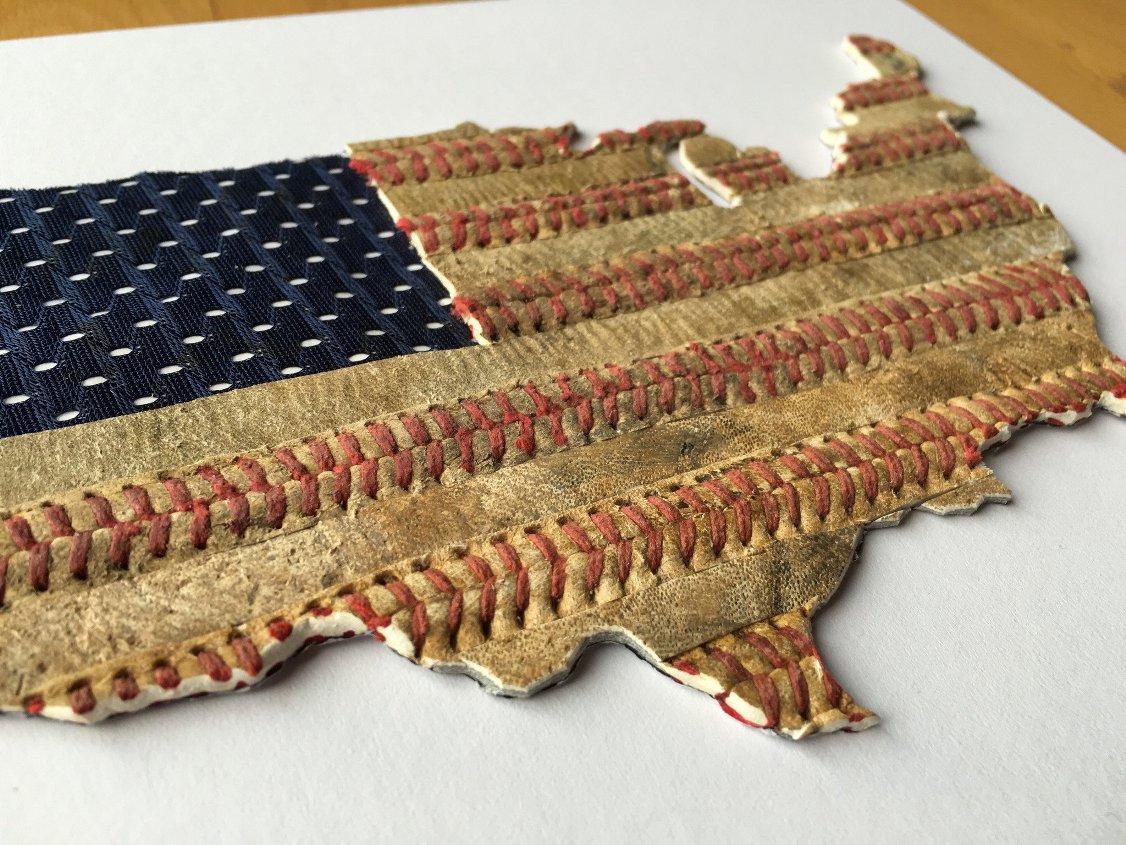 American flag made from baseballs on a white surface