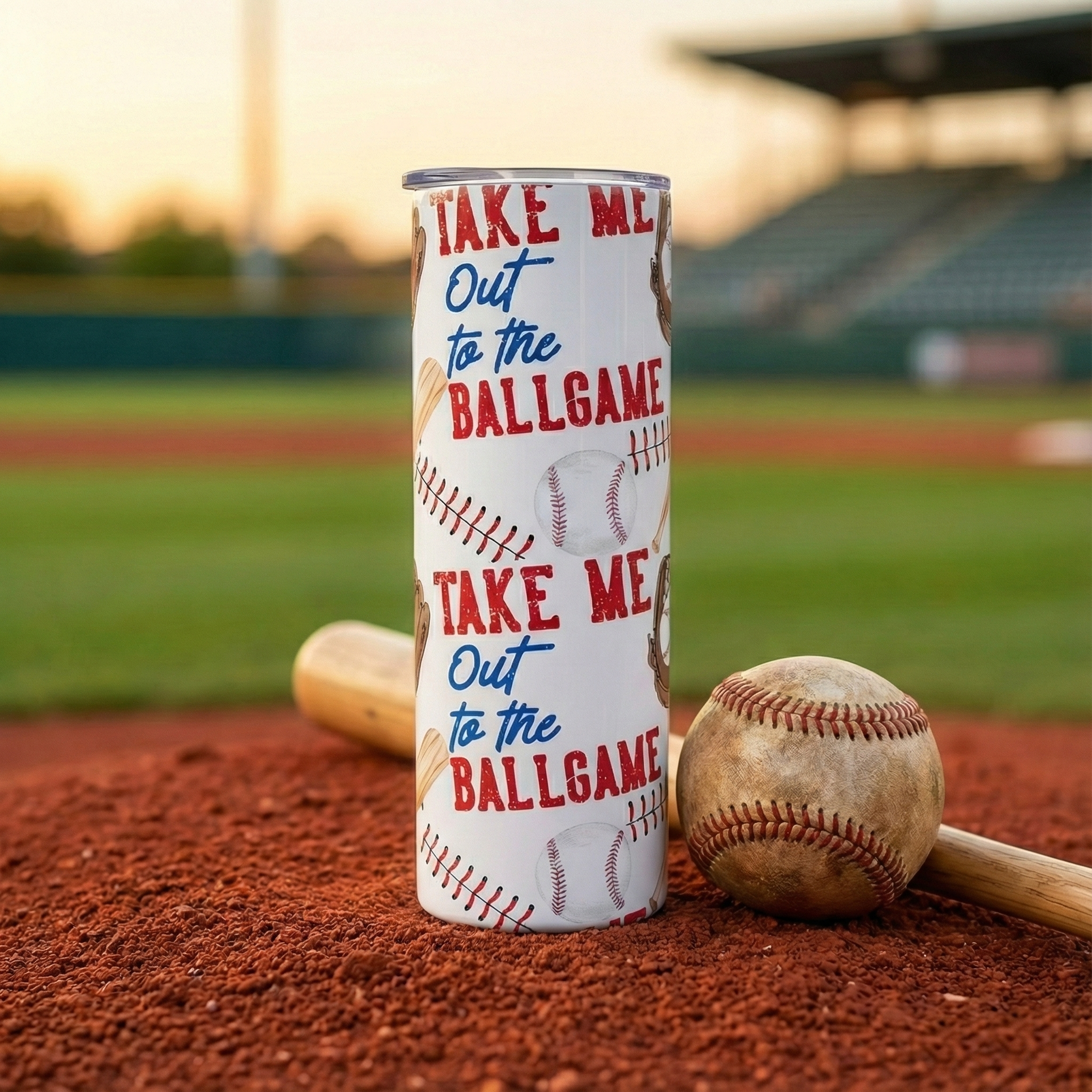 Skinny Baseball Tumbler with 'Take Me Out to the Ballgame' text on a baseball field background
