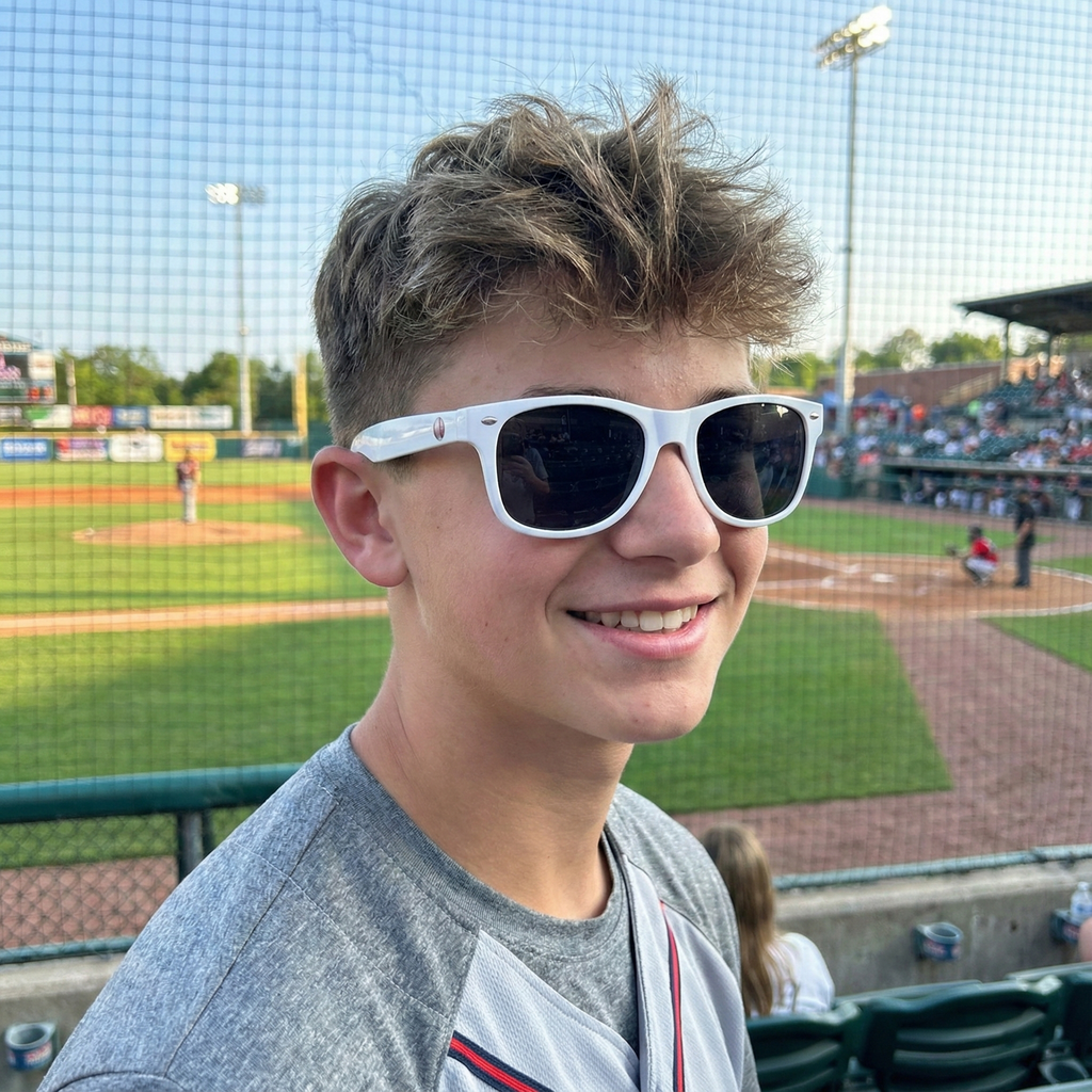 Person wearing white sunglasses at a baseball game