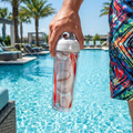 Person holding a baseball Tervis water bottle tumbler with a baseball design by a pool