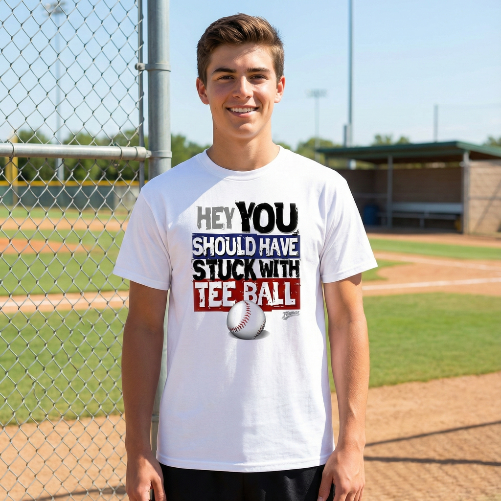 Person wearing a white t-shirt with a humorous baseball-themed message on a baseball field.