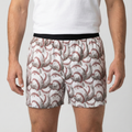 Person wearing boxer shorts with baseball pattern on a plain background