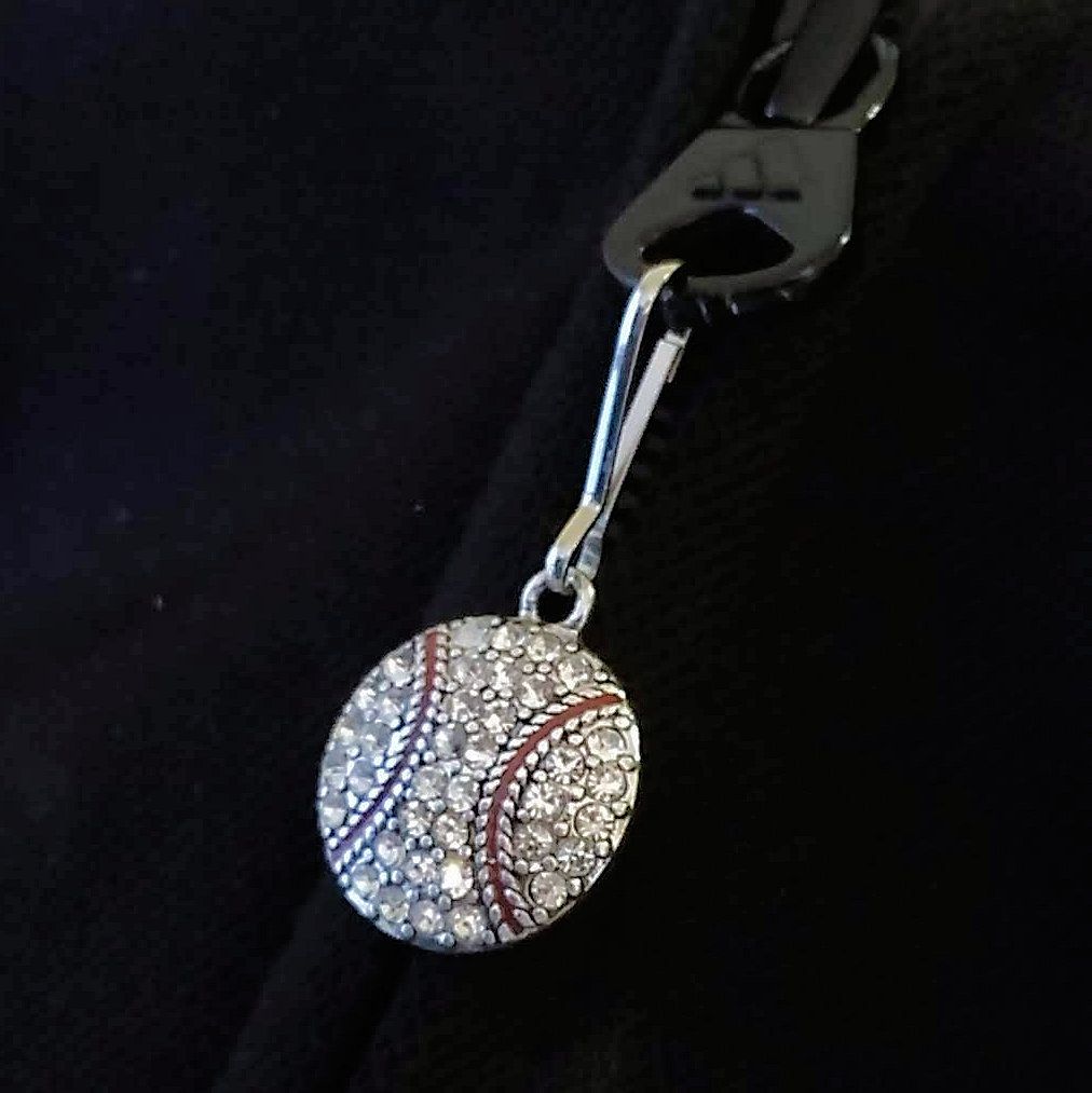 Decorative keychain with a baseball design on a black background