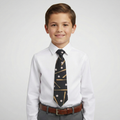 Young boy wearing a white shirt, black baseball tie with bats and balls, and gray pants on a light gray background