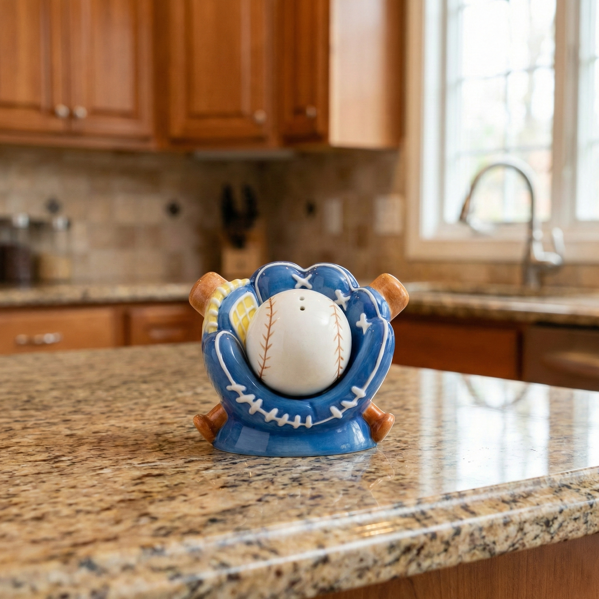 Blue Baseball Mitt Ceramic Salt and Pepper Shaker Set on a granite countertop in a nice kitchen