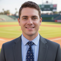 Man in a suit and tie standing on a baseball field