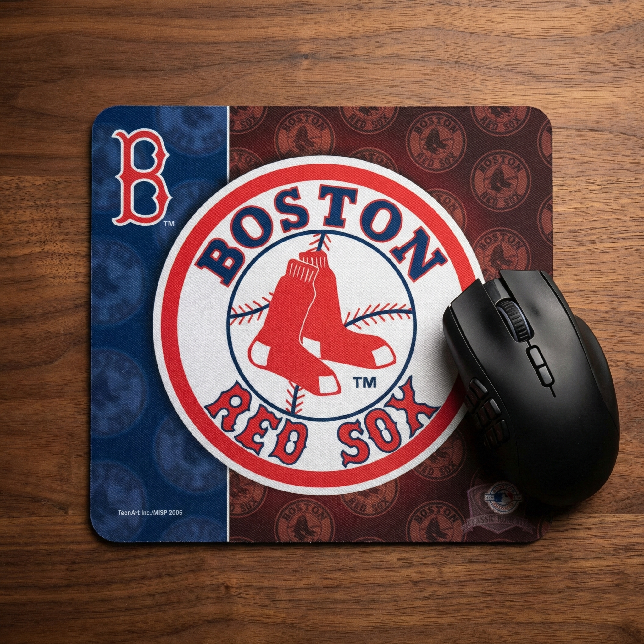 Mouse pad with Boston Red Sox logo and a black mouse on a wooden surface