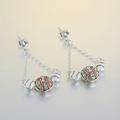 Pair of baseball drop earrings on a light background